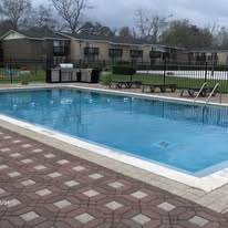 A small pool with a brown tile floor.
